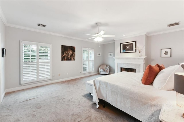 bedroom with ceiling fan, crown molding, carpet, and a premium fireplace