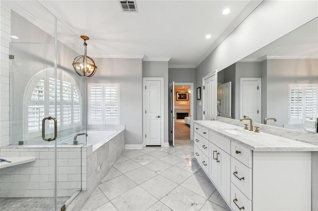 bathroom with shower with separate bathtub, vanity, a notable chandelier, and ornamental molding