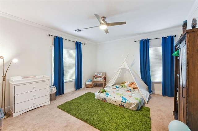 bedroom featuring ceiling fan, light colored carpet, crown molding, and multiple windows