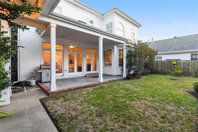 rear view of house with a patio area and a yard