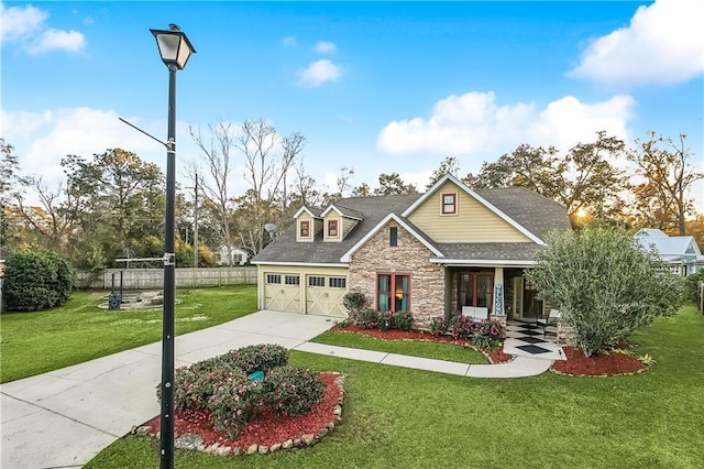 17198 Bridle Path, Hammond, LA 70403 - craftsman-style home with fence, driveway, a front lawn, and stone siding