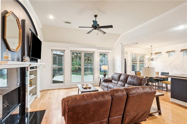 17198 Bridle Path, Hammond, LA 70403 - living room featuring visible vents, a healthy amount of sunlight, light wood finished floors, and ceiling fan with notable chandelier