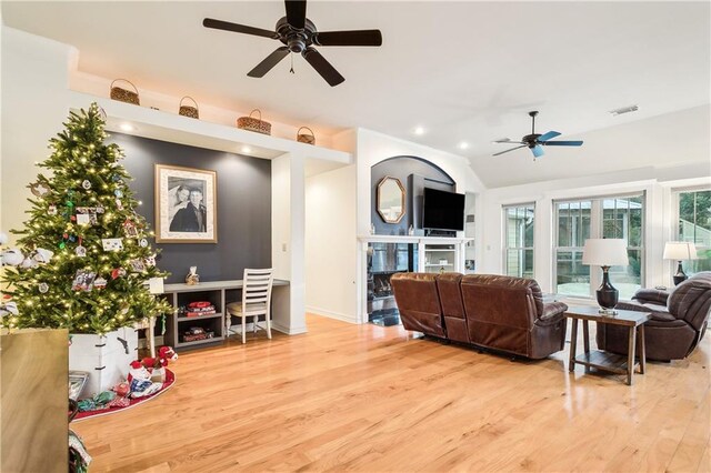 living room with ceiling fan and light hardwood / wood-style flooring