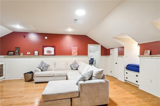 living room with hardwood / wood-style floors and vaulted ceiling