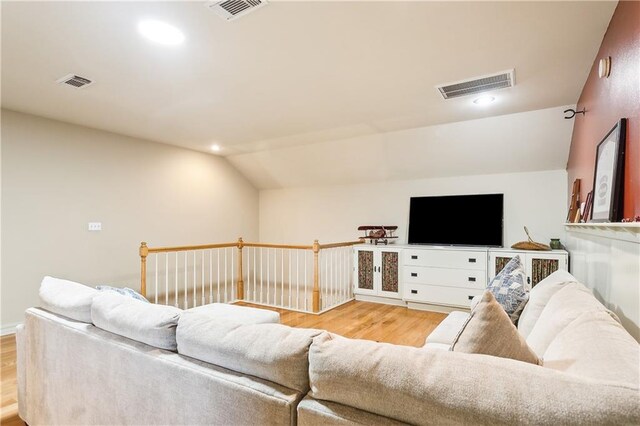 living room with lofted ceiling and light wood-type flooring