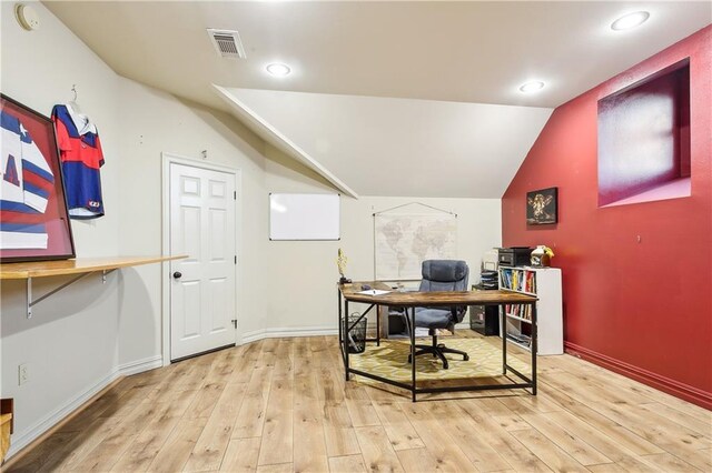 office area with light hardwood / wood-style floors and vaulted ceiling