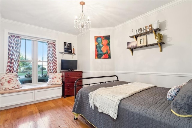 bedroom with light wood-type flooring, crown molding, and an inviting chandelier