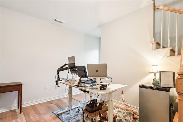 office area with light hardwood / wood-style flooring