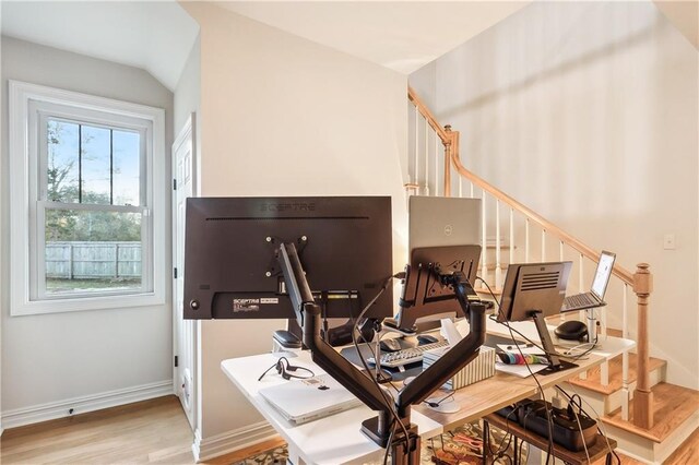 office space featuring wood-type flooring, a wealth of natural light, and vaulted ceiling