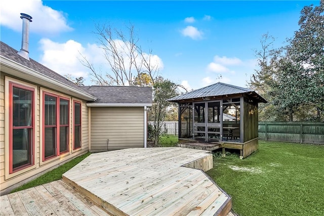 wooden deck with a sunroom and a yard