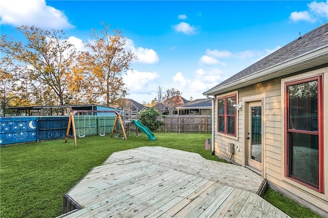 wooden terrace with a yard and a playground