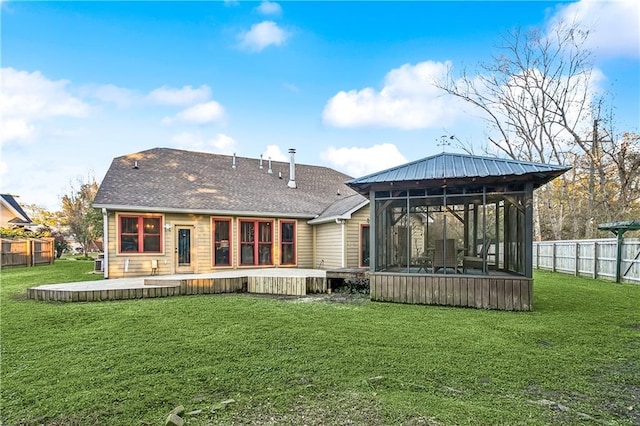 17198 Bridle Path, Hammond, LA 70403 - rear view of house with a sunroom, a lawn, and fence