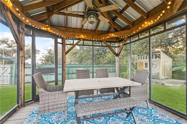 sunroom / solarium featuring ceiling fan and lofted ceiling with beams