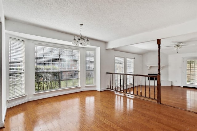 130 Village Dr Unit 130, Slidell, LA 70461 - empty room featuring a textured ceiling, ceiling fan with notable chandelier, and hardwood / wood-style flooring