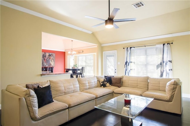 living room featuring ceiling fan with notable chandelier, ornamental molding, vaulted ceiling, and hardwood / wood-style flooring