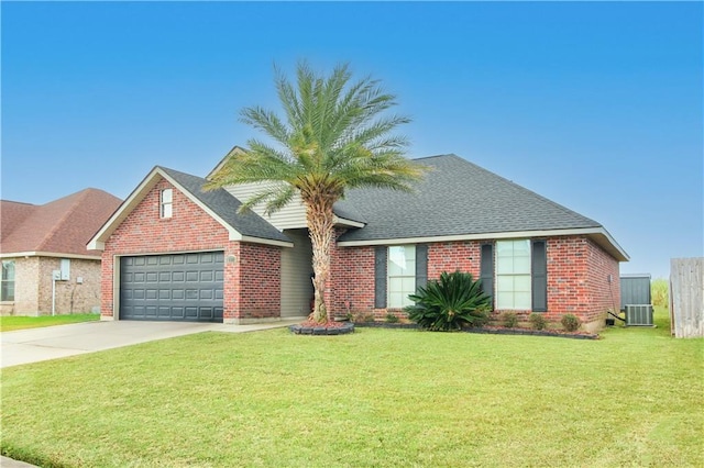 view of front of property with a front lawn, cooling unit, and a garage