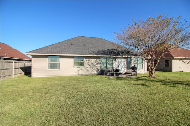 rear view of house featuring a patio area and a yard