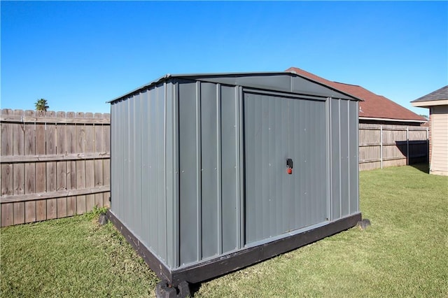 view of outbuilding featuring a lawn