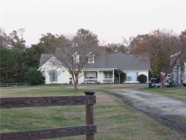 view of front of house with a porch and a front yard