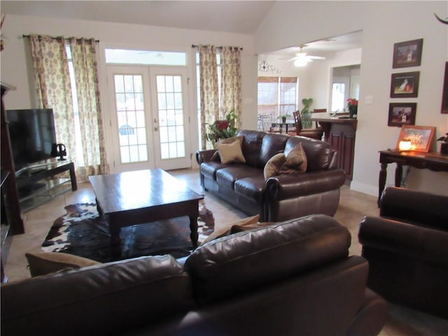 living room with french doors, light tile patterned floors, vaulted ceiling, and ceiling fan