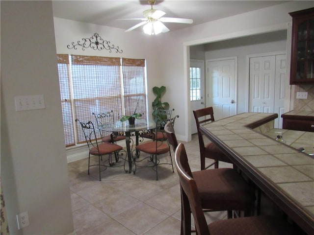 tiled dining room with ceiling fan