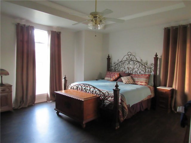 bedroom with dark hardwood / wood-style floors and ceiling fan