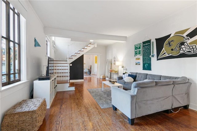 living room featuring wood-type flooring and ornamental molding