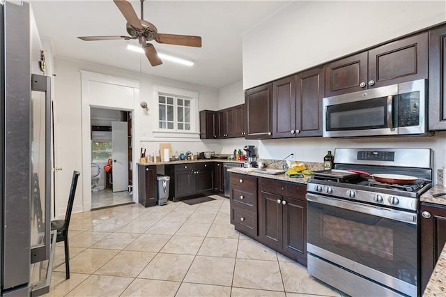 kitchen with light tile patterned flooring, light stone countertops, dark brown cabinetry, and appliances with stainless steel finishes