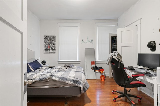 bedroom featuring crown molding and hardwood / wood-style floors