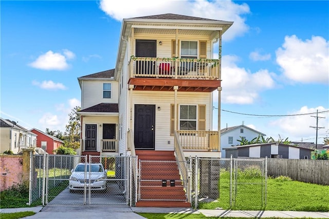 view of front of property with covered porch, a balcony, and a front lawn