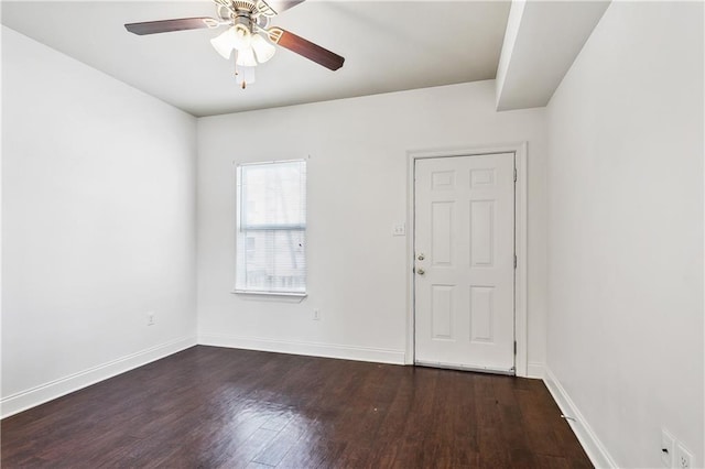 empty room featuring ceiling fan and dark wood-type flooring