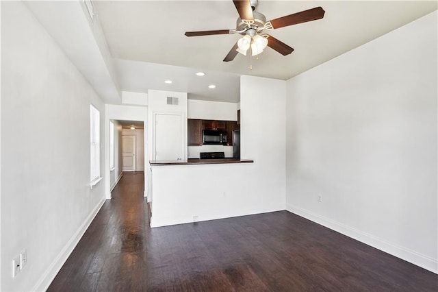 unfurnished living room featuring dark hardwood / wood-style floors and ceiling fan