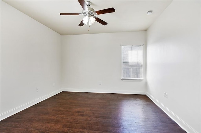 empty room with ceiling fan and dark hardwood / wood-style flooring