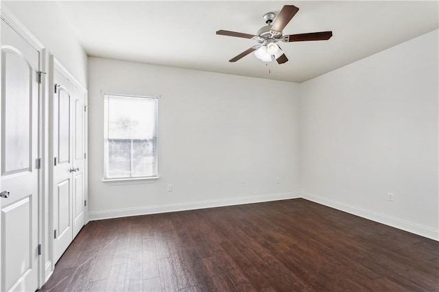 unfurnished room with ceiling fan and dark wood-type flooring