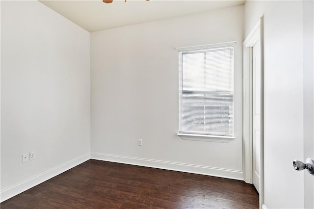 empty room with dark hardwood / wood-style flooring