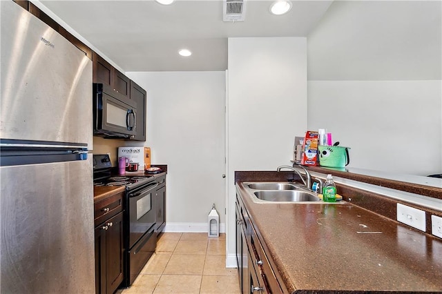 kitchen with sink, light tile patterned floors, black appliances, and dark brown cabinets