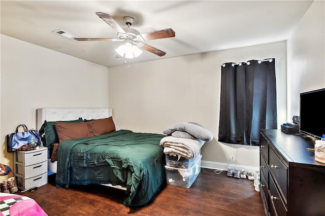 bedroom with ceiling fan and dark hardwood / wood-style floors