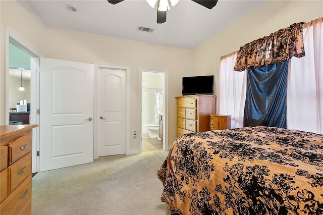 bedroom with ensuite bath, ceiling fan, and light colored carpet