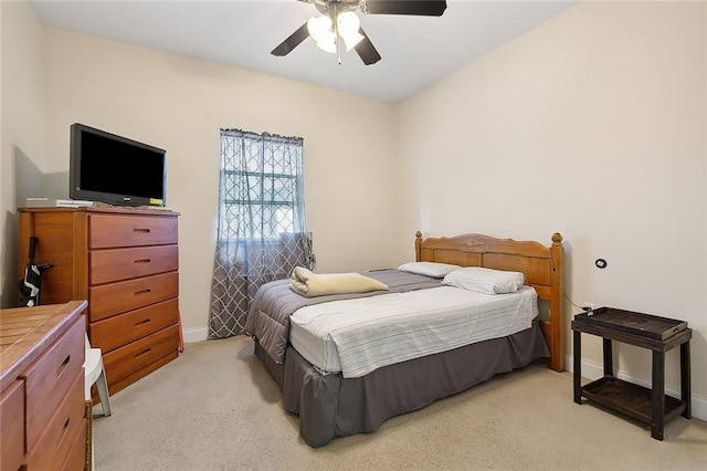 bedroom with ceiling fan and light carpet