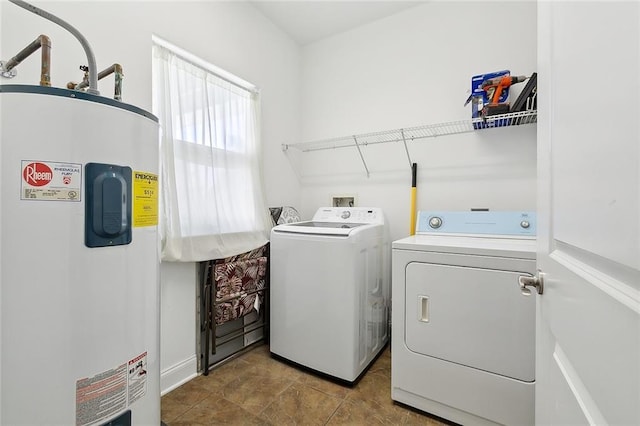 laundry area with tile patterned floors, washer and dryer, and electric water heater