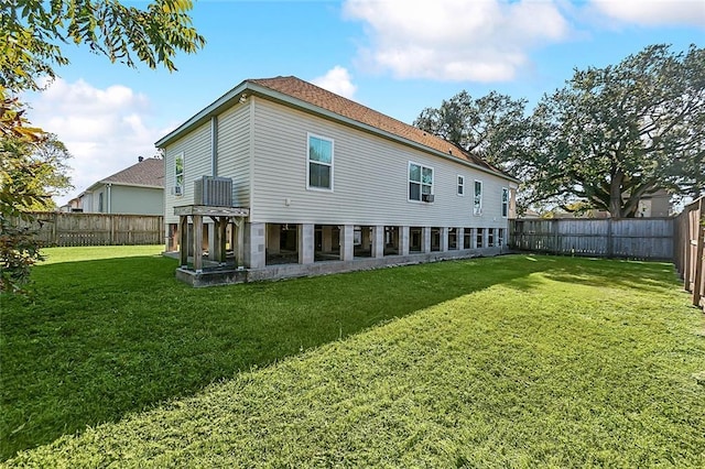 rear view of property with a lawn