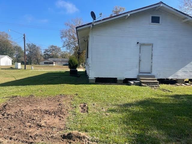 view of property exterior with a yard