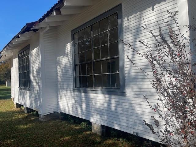 view of side of home featuring a lawn