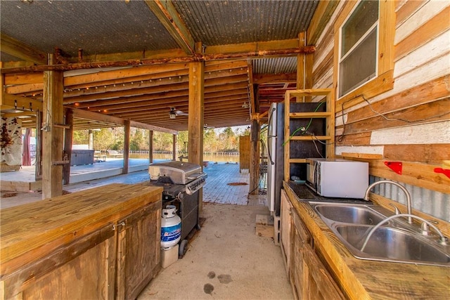 view of patio with a grill and sink