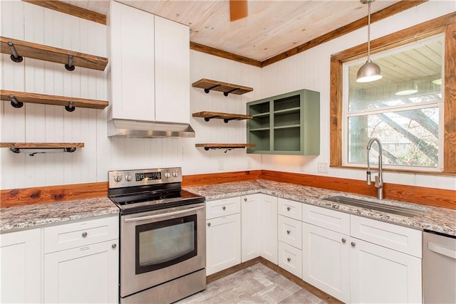 kitchen with light stone countertops, white cabinetry, sink, stainless steel appliances, and extractor fan