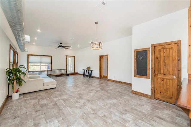 unfurnished living room featuring light hardwood / wood-style flooring and ceiling fan with notable chandelier