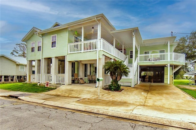 view of front facade with covered porch and a carport