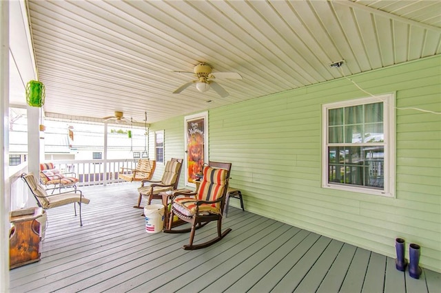 wooden terrace featuring a porch and ceiling fan