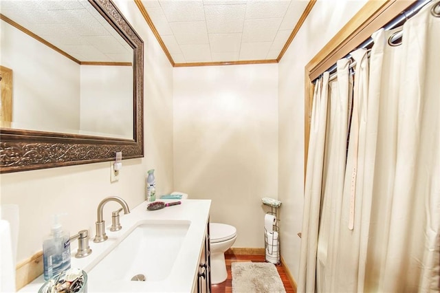 bathroom featuring crown molding, vanity, and toilet