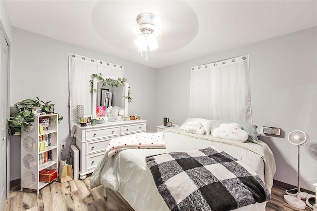 bedroom featuring ceiling fan and light hardwood / wood-style flooring